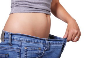 Woman stretching pants showing loss of weight