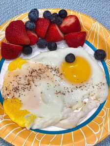 Plate of eggs, strawberries and blueberries