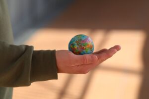 Photo of man holding small globe