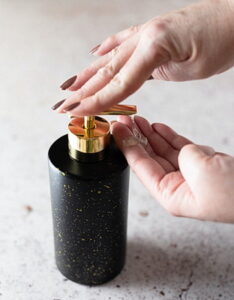 Woman washing her hands with antibacterial soap