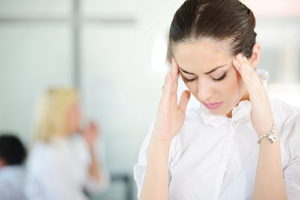 Woman showing signs of headach or stress