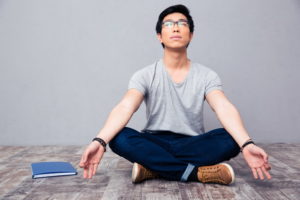 Young asian man meditating