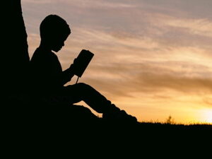 Boy reading in low lit conditions