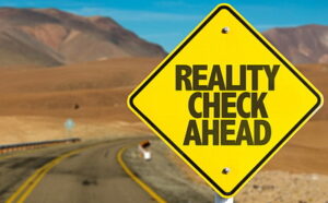 Road sign that says Reality Check Ahead Re: Myths