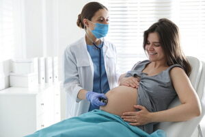 Doctor Examining Woman Before Giving Child Birth