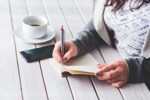 Woman writing on a notepad