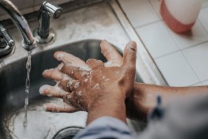 Man washing his hands in a sink