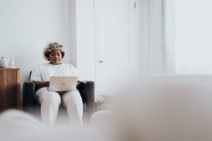 Woman sitting on chair working on laptop