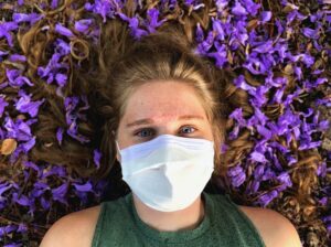 Woman lying down with mask