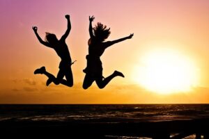 Silhouettes of people jumping for joy