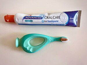 Toothpaste and toothbrush on a white table